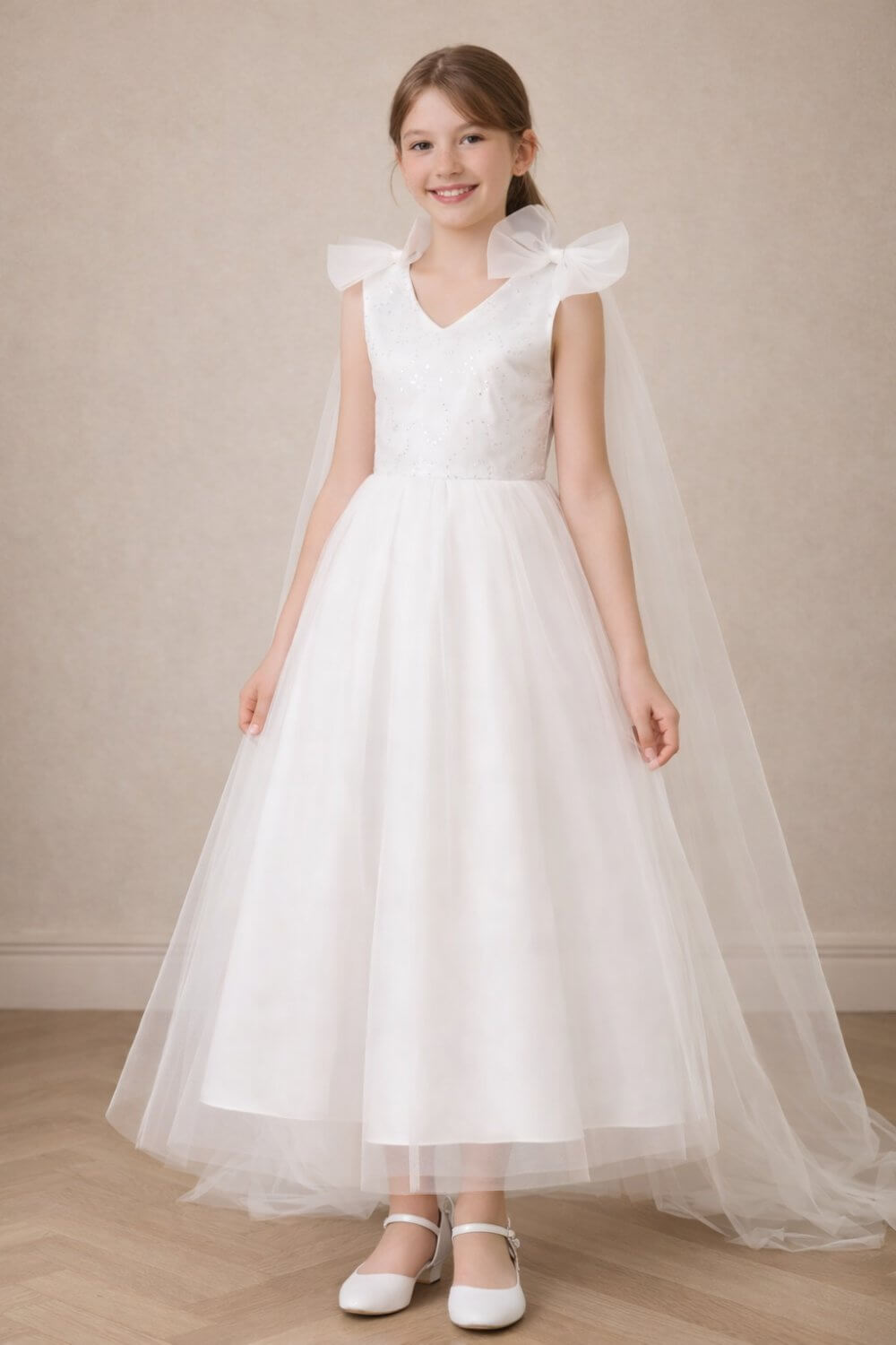 Front view of the Aria ivory white flower girl dress, featuring a subtle sequin V-neck bodice and a voluminous A-line tulle skirt.