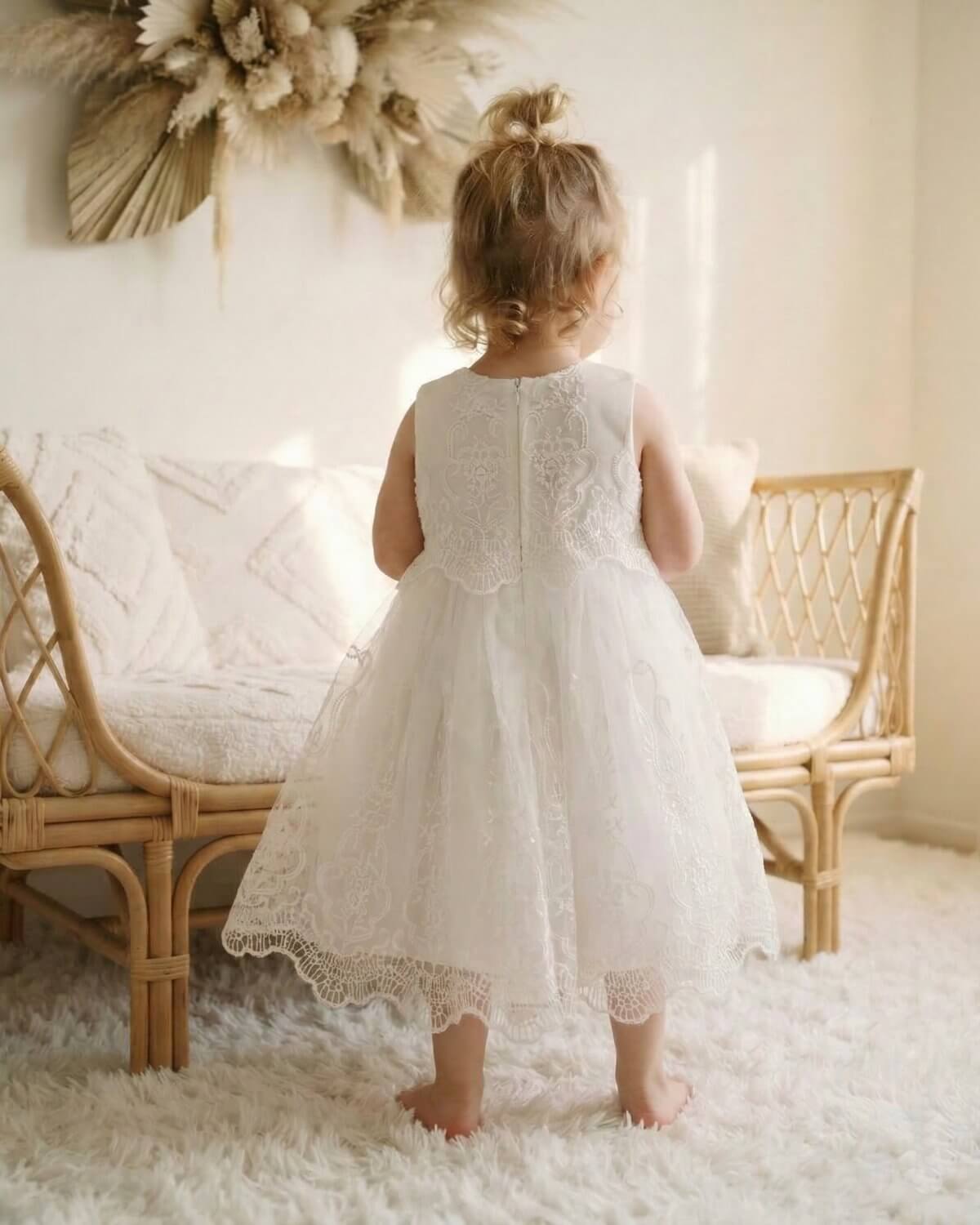 Back view of toddler girls ivory lace and tulle flower girl dress showcasing the elegant sheer back design and A-line silhouette