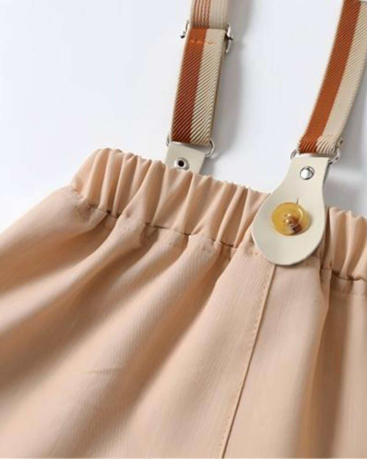 Back view detail of boys beige wedding shorts with a flexible elastic waistband and retro striped suspenders