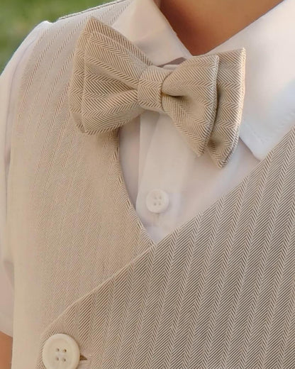Close-up of boys page boy beige linen vest with a matching herringbone bow tie and crisp white dress shirt