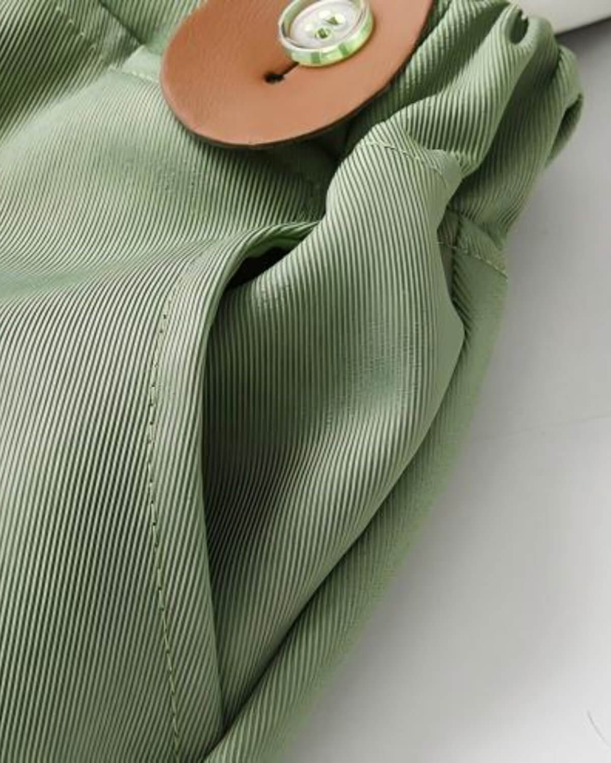 etailed view of boys sage green page boy suit pants featuring premium twill textured fabric and a functional side pocket