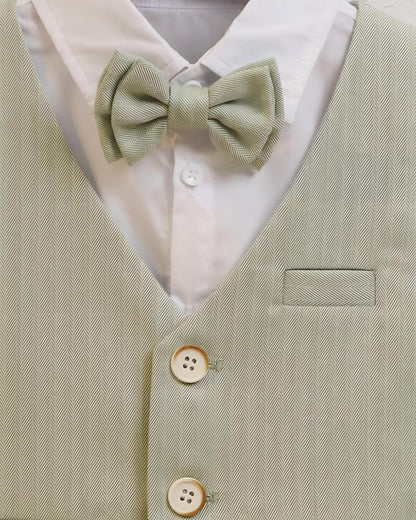 Close-up of matching sage green herringbone bow tie and crisp white dress shirt collar.