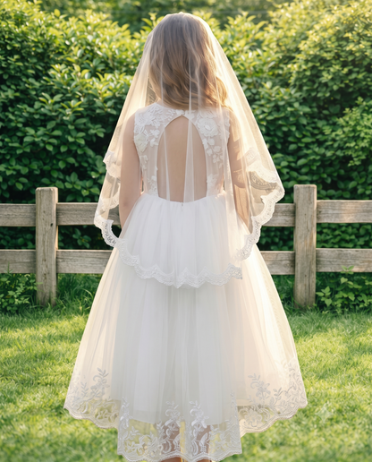 Back view of the white flower girl dress showing the elegant illusion lace cut-out back and layered tulle veil.