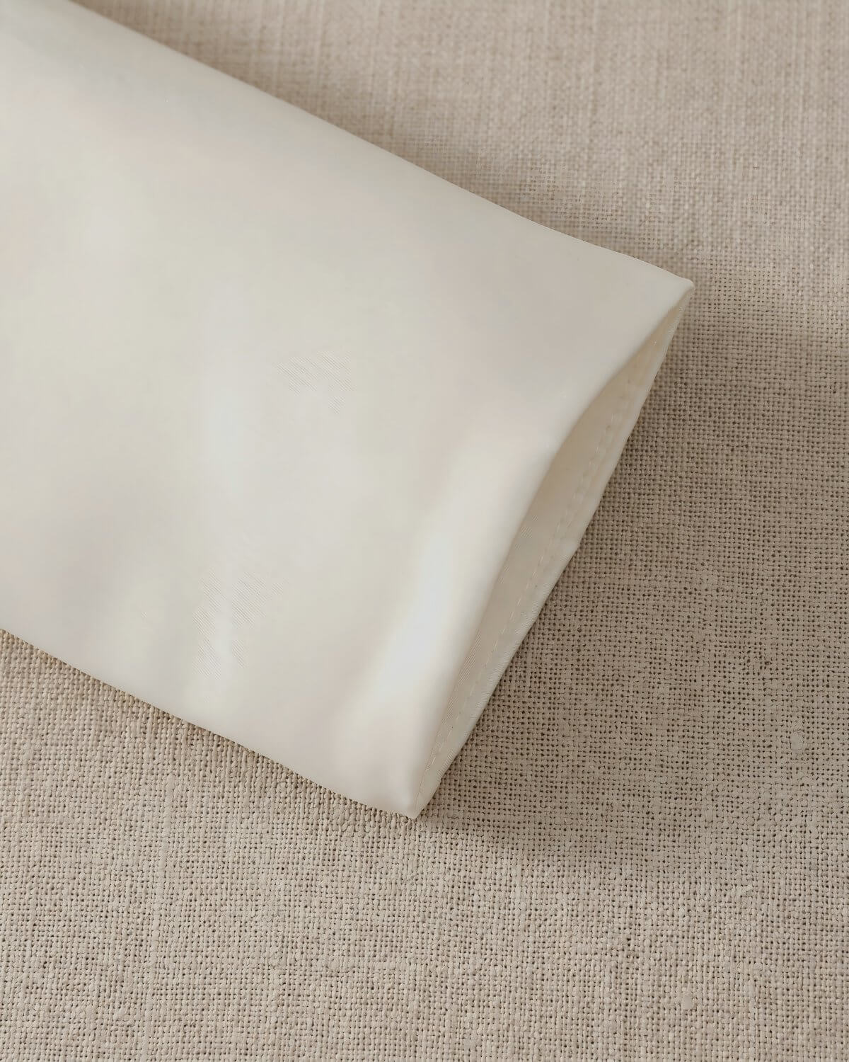 Close-up view of the clean, minimalist long sleeve cuff on the girls premium matte satin formal wedding jacket.