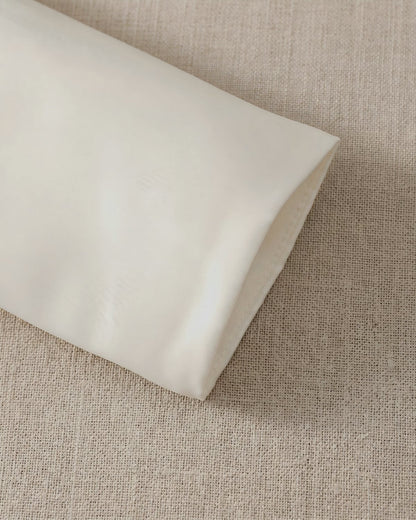 Close-up view of the clean, minimalist long sleeve cuff on the girls premium matte satin formal wedding jacket.